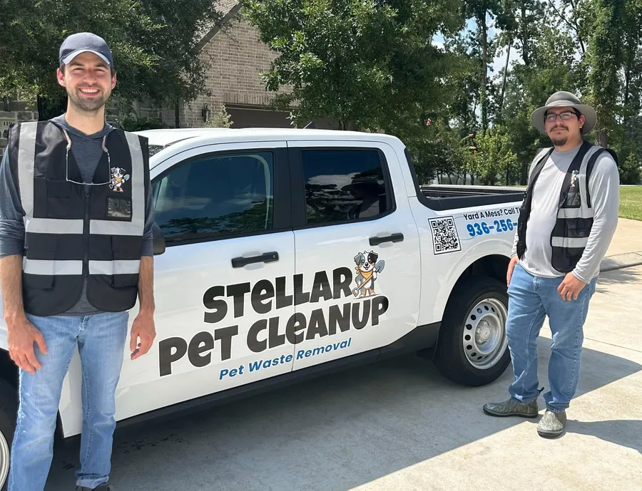 Two Stellar Pet Cleanup team members standing beside the company truck