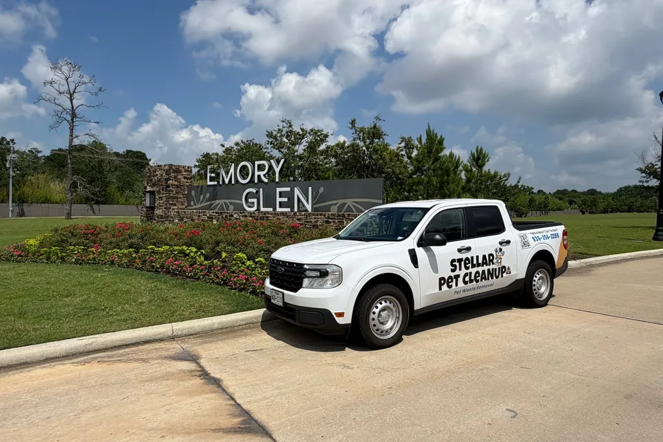 Stellar Pet Cleanup truck parked at the Emory Glen neighborhood entrance in Magnolia