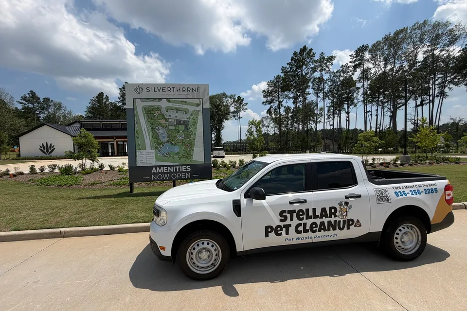 Stellar Pet Cleanup truck parked by the Silverthorne community sign in Conroe